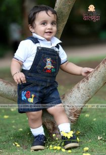 Baby standing near a tree during his photo Session in Balmudra Studio Pune
